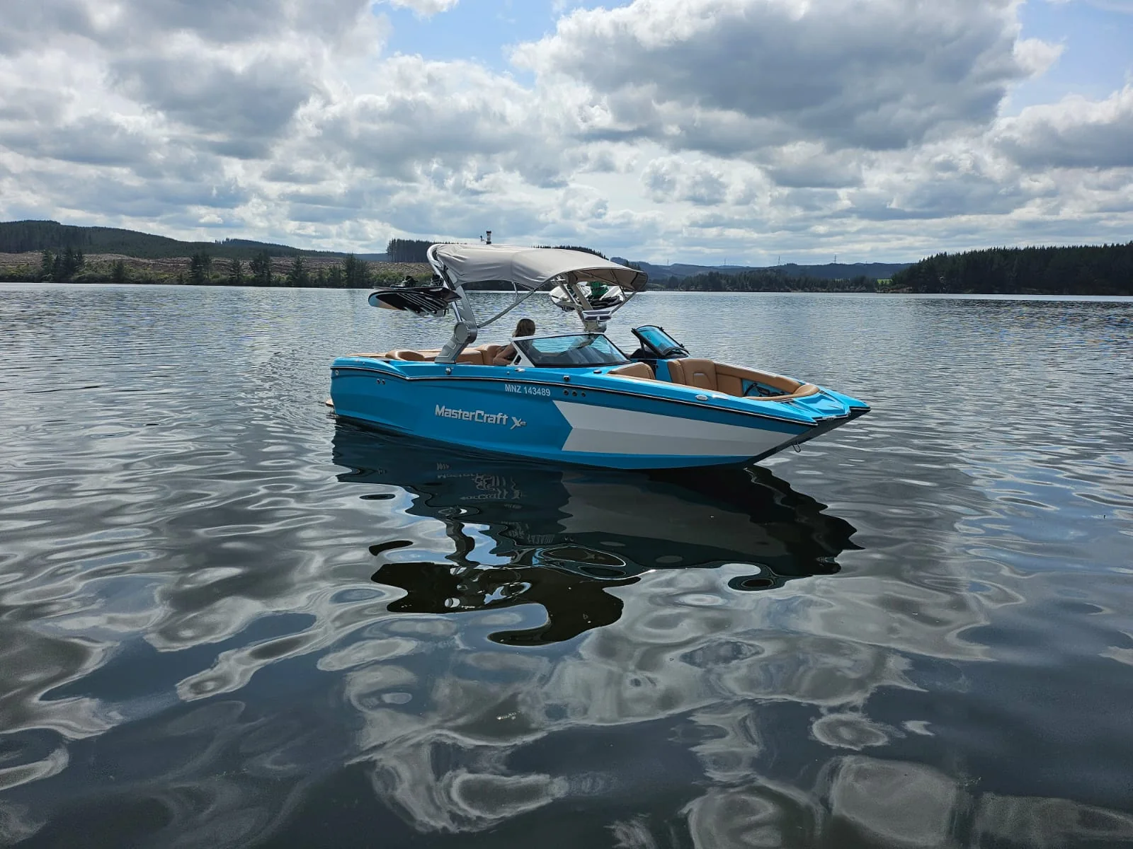 Blue MasterCraft XStar wake boat on Lake Maraetai