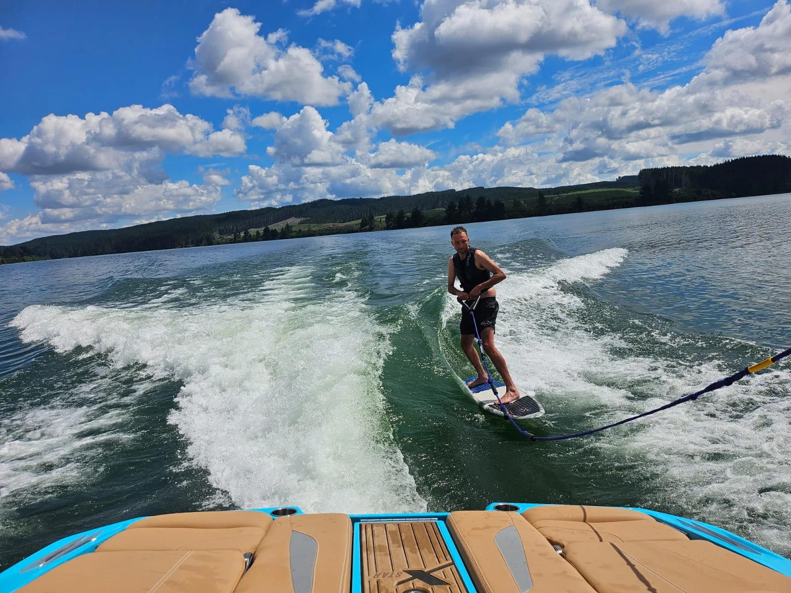 Wakesurfer riding the wake on Lake Maraetai