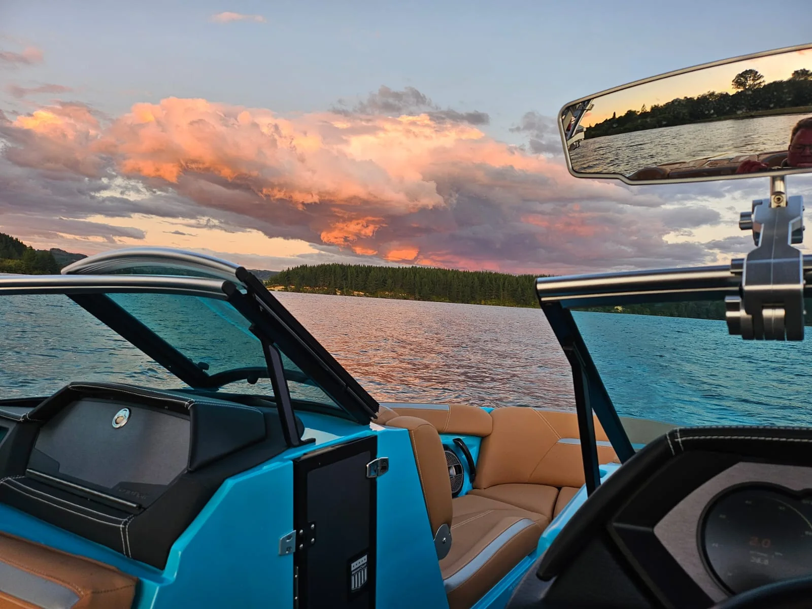 Wake boat tower and boards at sunset